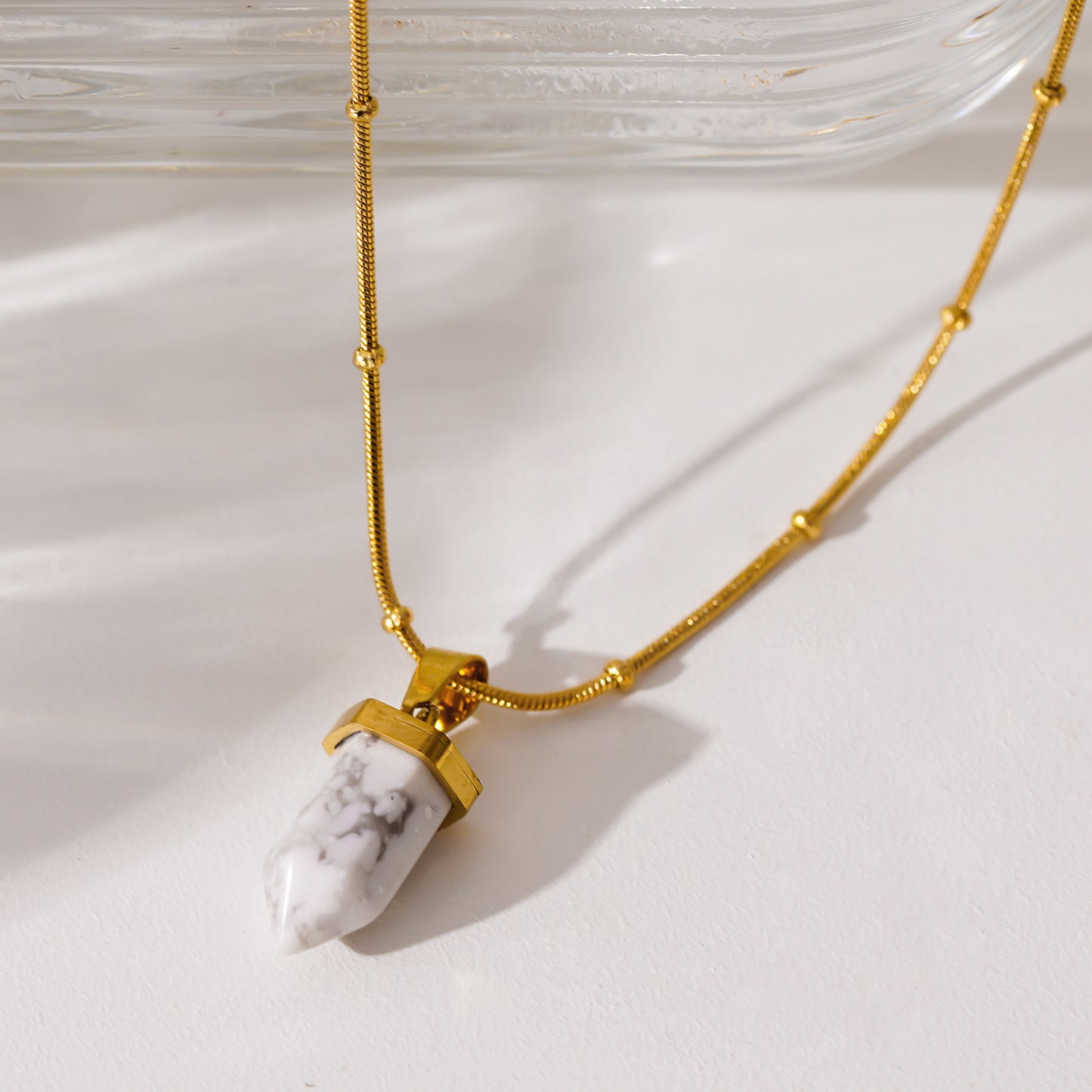 Style AMELIE 2330: White Turquoise Stone Pendant Anchored on a Beaded Snake Skin Textured Chain Necklace.