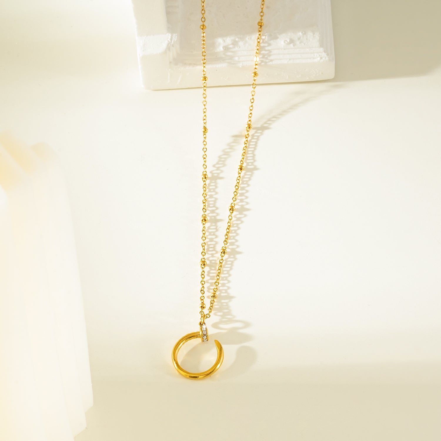 CSENGE Gold Necklace:  Zirconia Embedded Circular Nail Pendant on a Satellite Beaded Chain