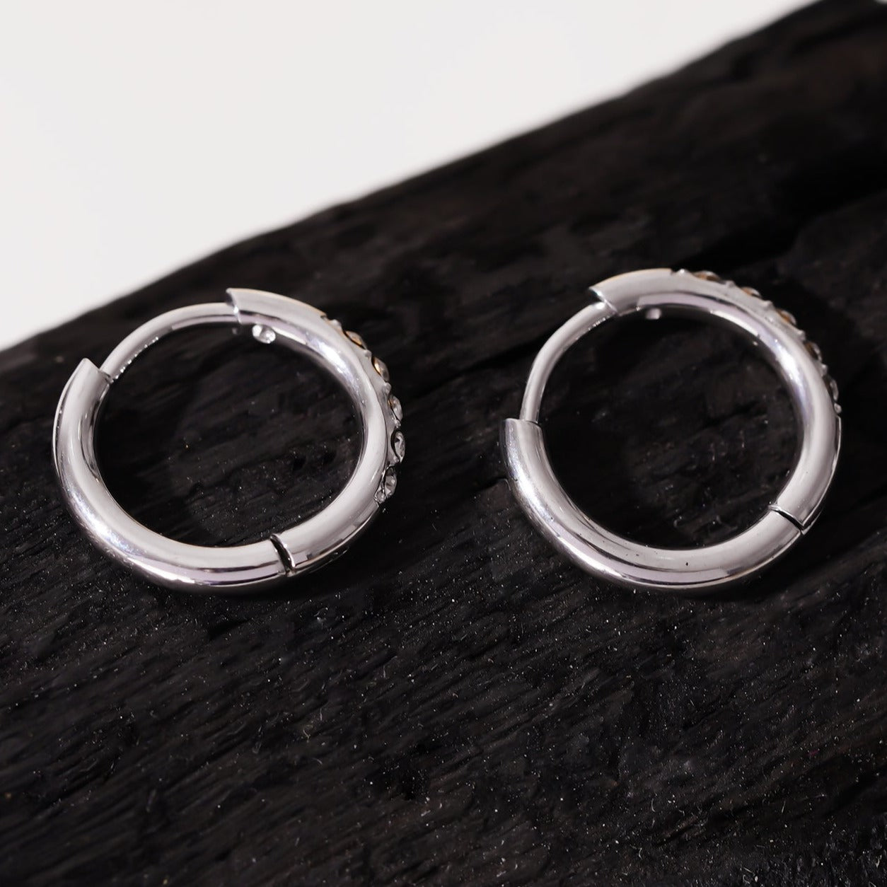 Style DARCI 22117: Pavé Zirconia Gemstones Embedded on a Classic Mini Hoop in Silver.