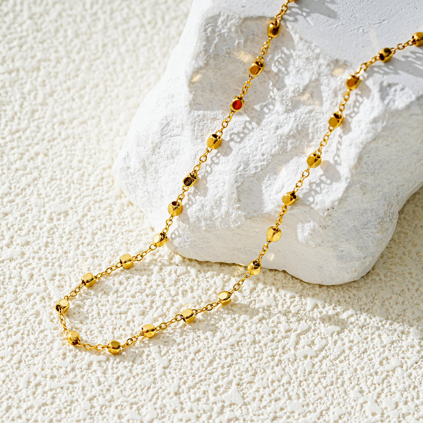 Style DEMELZA 8191G: Contemporary Gold Anklet with Delicate Square Beads. 