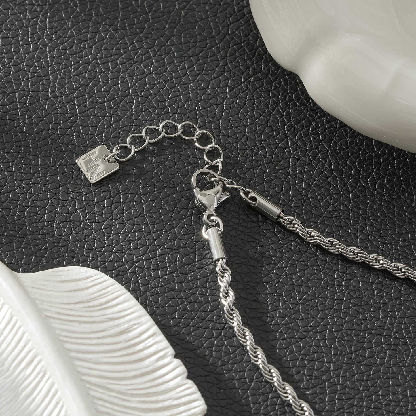 COSMINA Mixed Metals: Silver Rope Chain Necklace with Triple Mini Gold Criss-Cross Charms