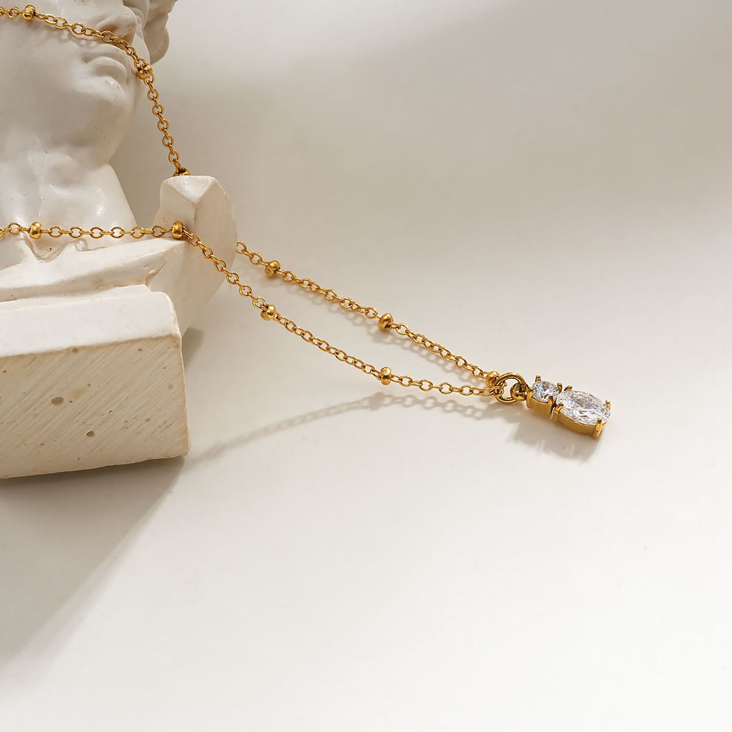 CABBANA Gold: A Duo Set of Zirconia Charm Pendants on a Beaded Chain Necklace