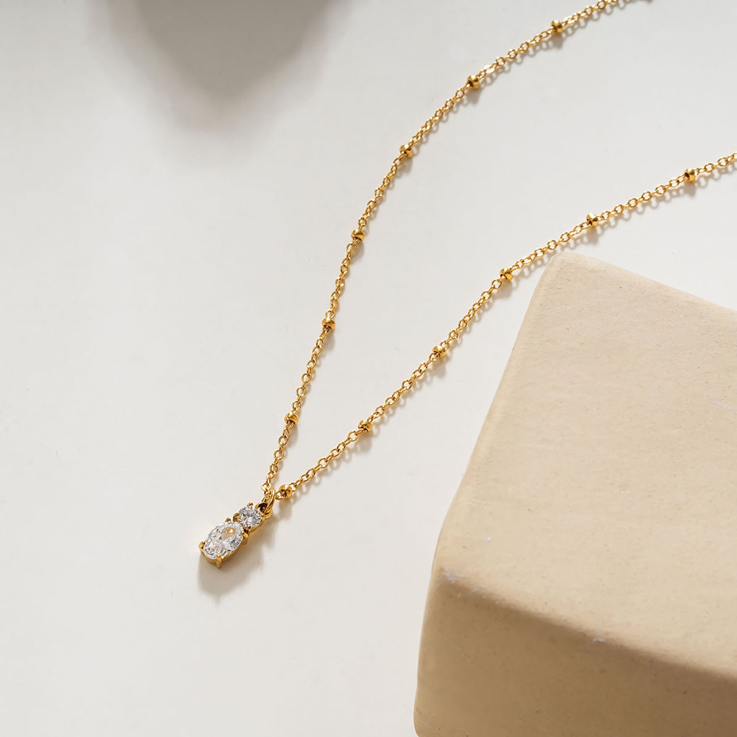 CABBANA Gold: A Duo Set of Zirconia Charm Pendants on a Beaded Chain Necklace