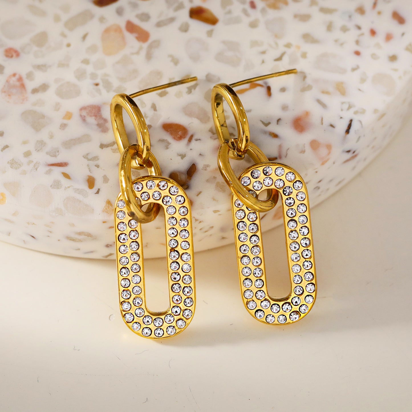 Style LAIA 76857: Rounded Rectangle Shaped Earrings embedded with Zirconia Gemstones.