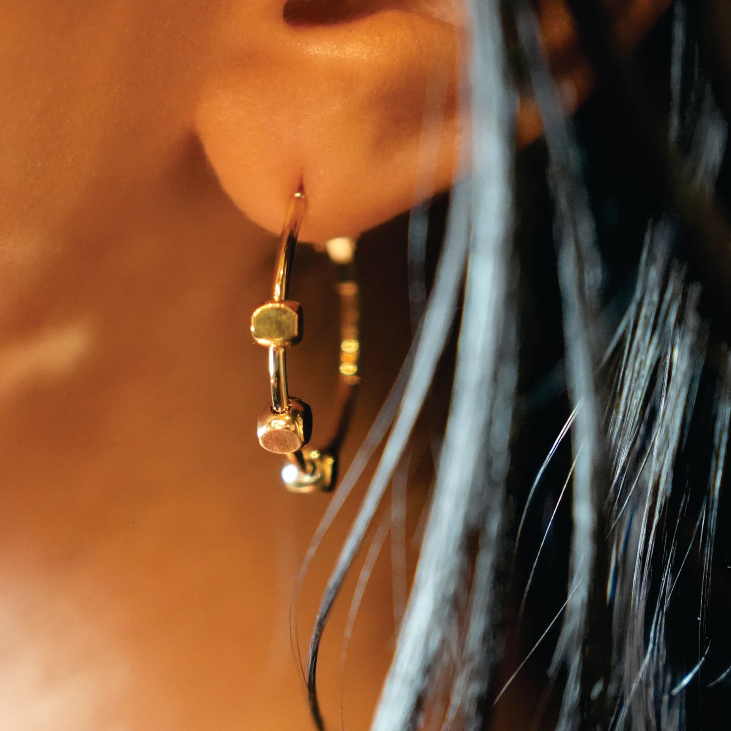 Style MASUYO 1079: Avant-Garde Rounded Hoop Earrings Anchoring a Trio of Square Beads.