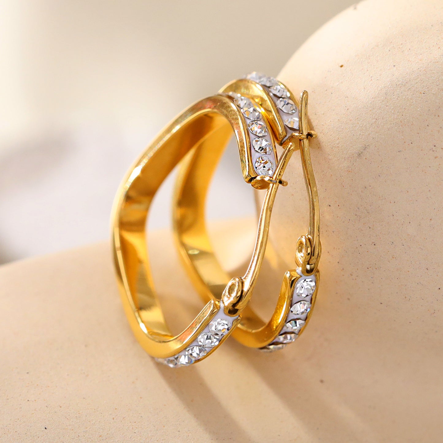 Style MELFI 08565: Rounded Triangle Shaped Hoops embedded with Zirconia Gemstones.