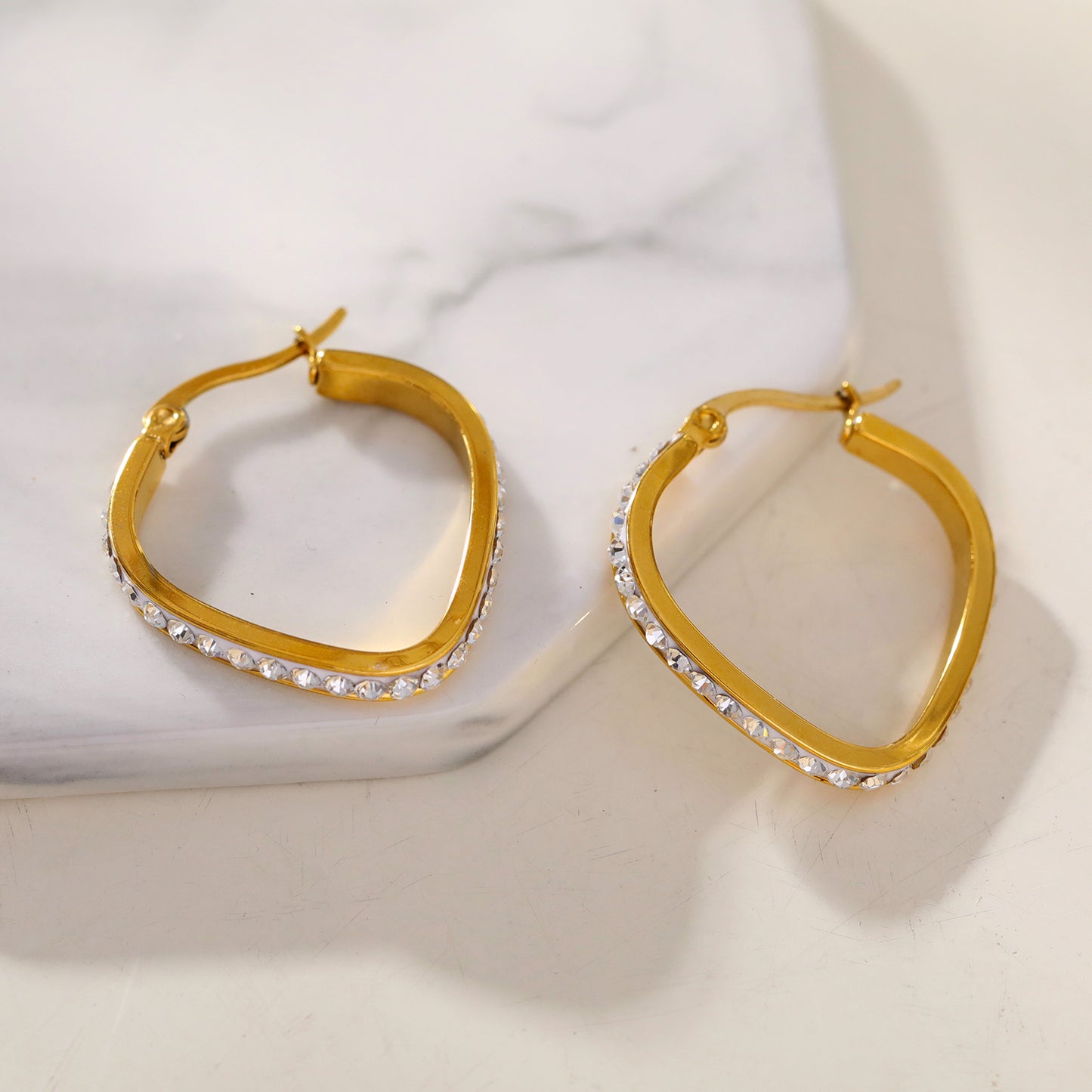 Style MELFI 08565: Rounded Triangle Shaped Hoops embedded with Zirconia Gemstones.