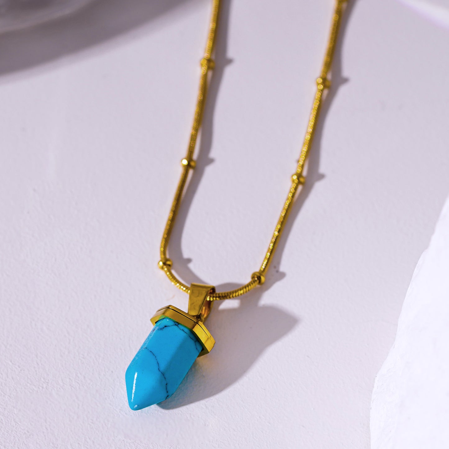 PIPPA: African Turquoise Stone Pendant Anchored on a Beaded Snake Skin Textured Chain Necklace.