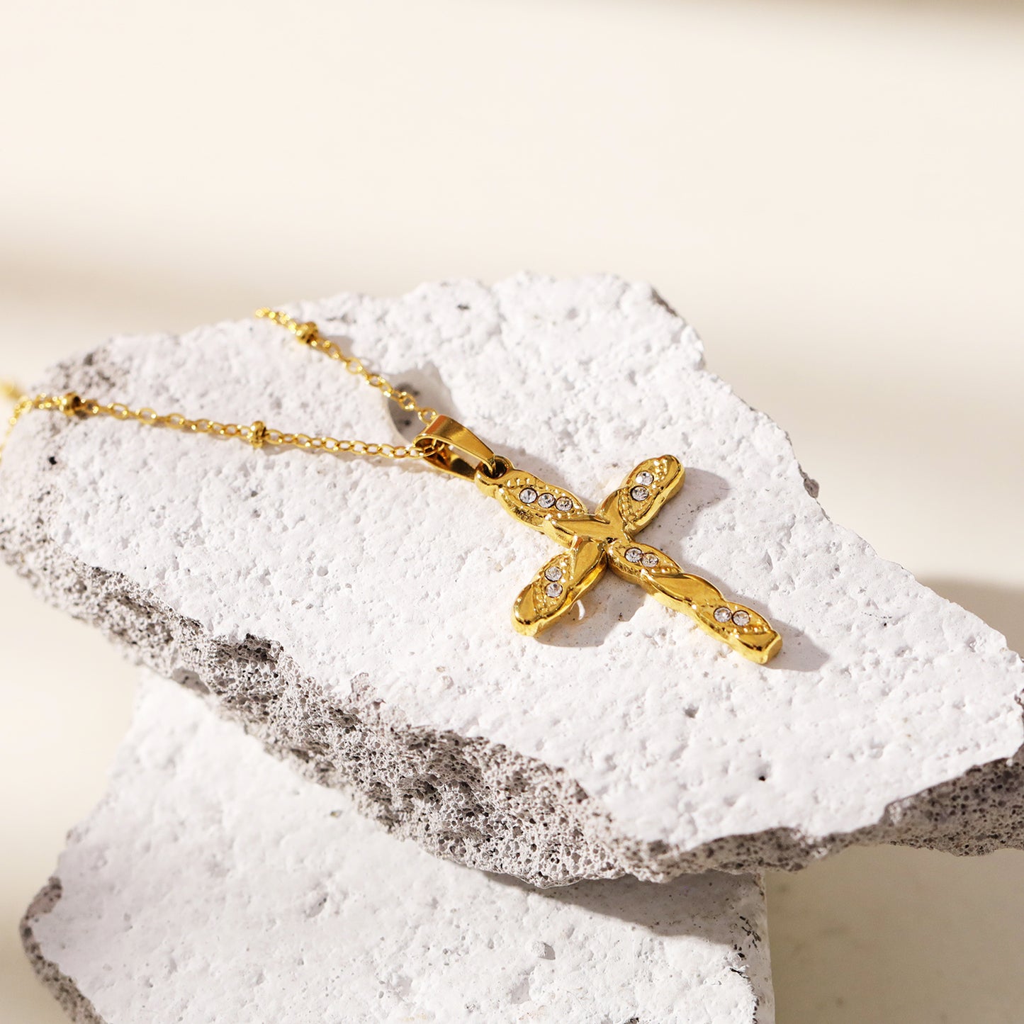 CHAMONIX: Dainty Beaded Chain Necklace with a Zirconia Embedded Textured Cross Pandent