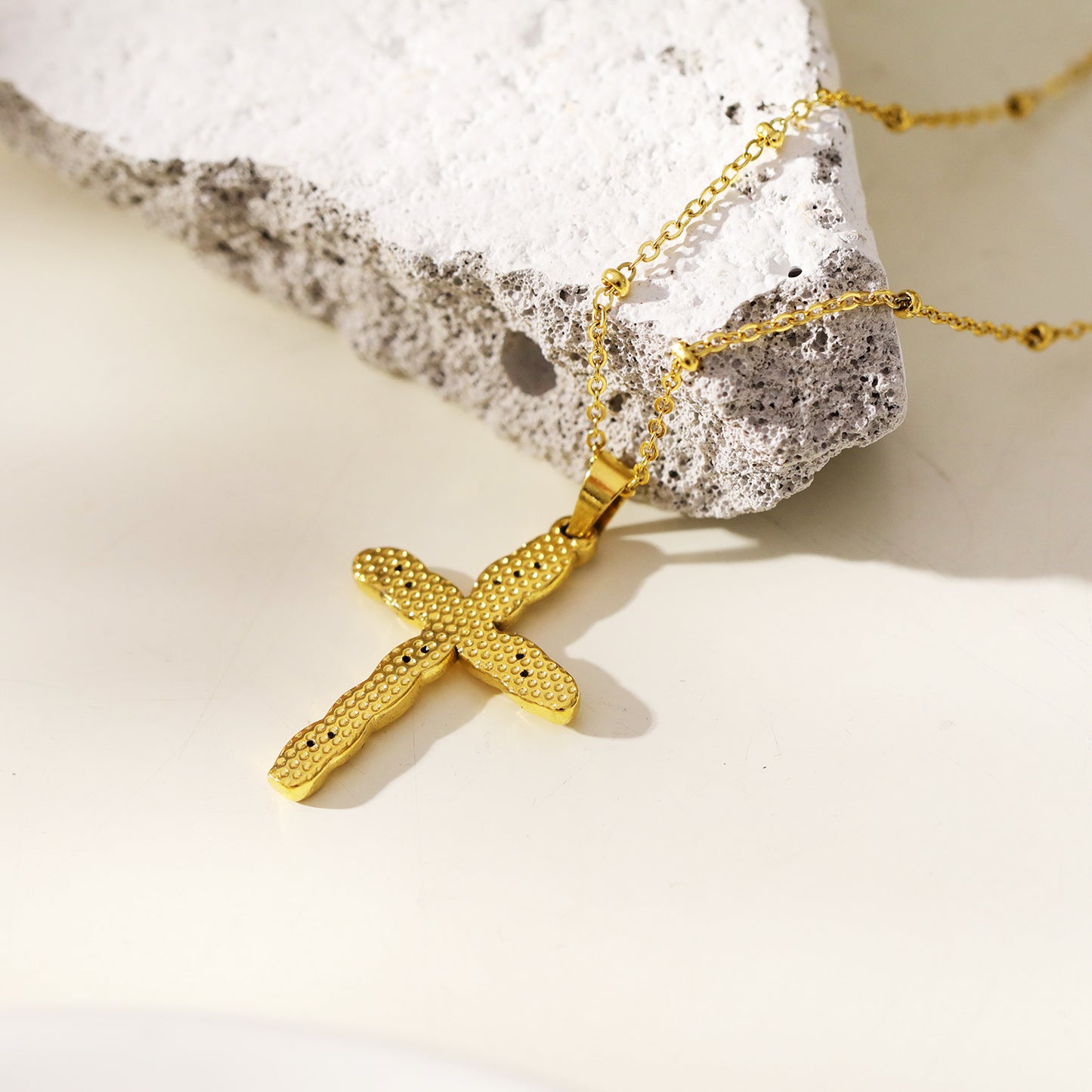 CHAMONIX: Dainty Beaded Chain Necklace with a Zirconia Embedded Textured Cross Pandent