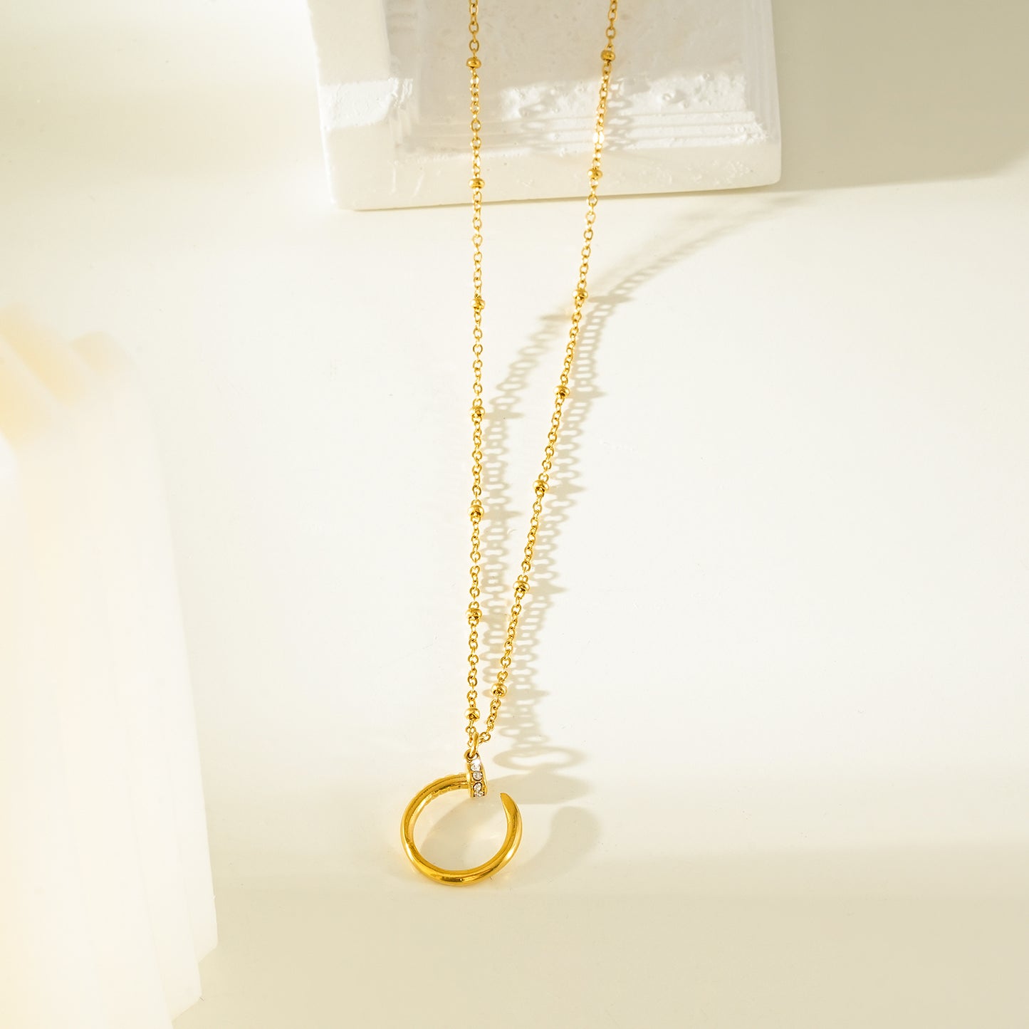 CSENGE Gold Necklace:  Zirconia Embedded Circular Nail Pendant on a Satellite Beaded Chain