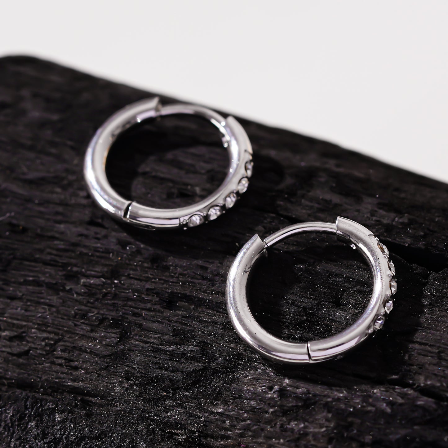 Style DARCI 22117: Pavé Zirconia Gemstones Embedded on a Classic Mini Hoop in Silver.