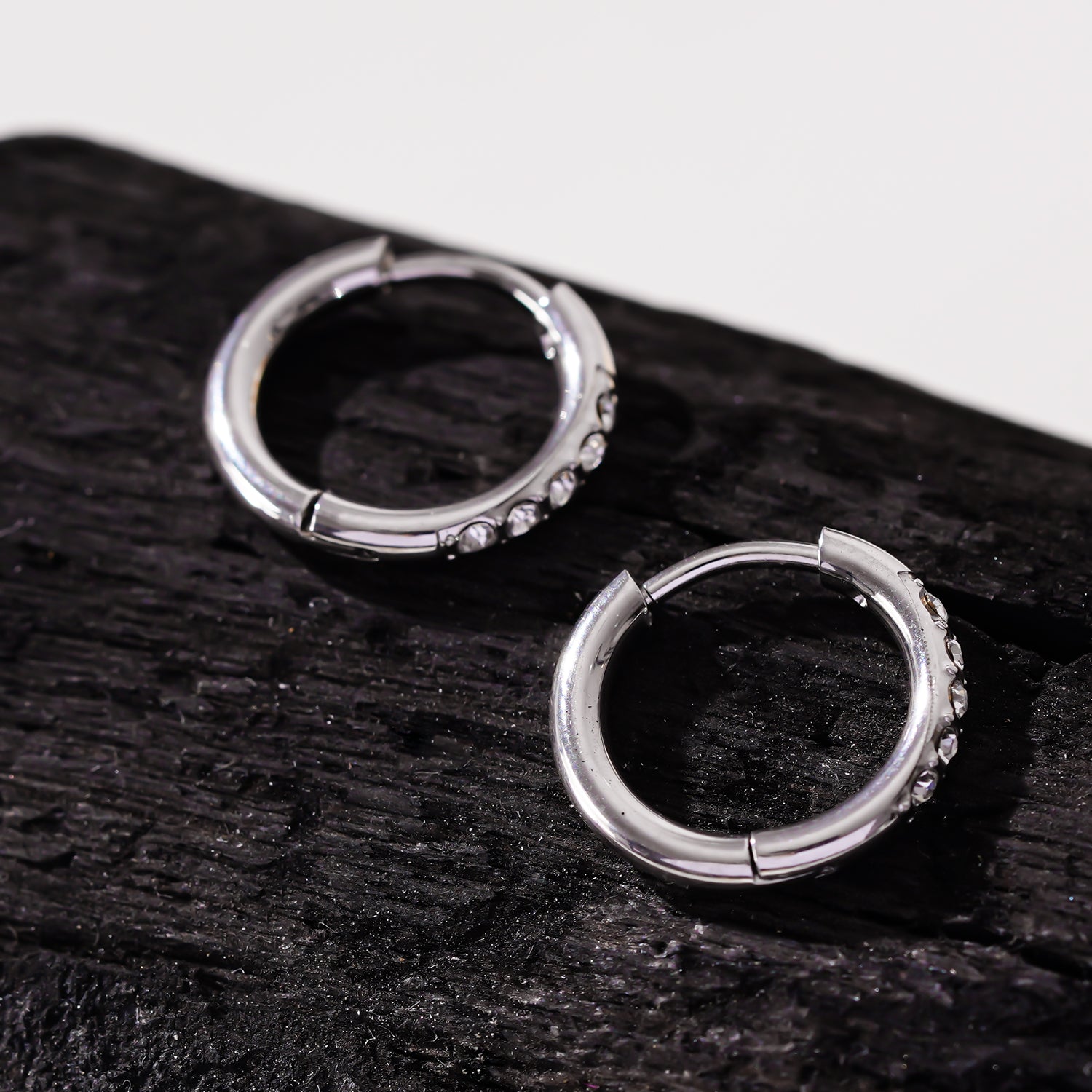 Style DARCI 22117: Pavé Zirconia Gemstones Embedded on a Classic Mini Hoop in Silver.