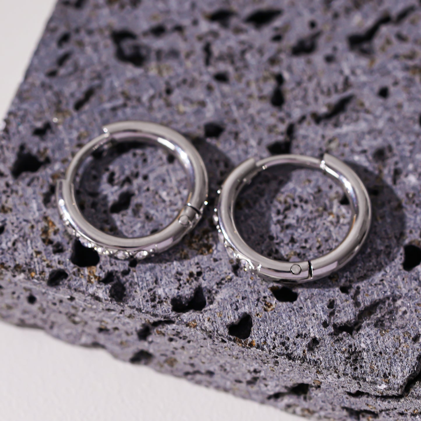 Style DARCI 22117: Pavé Zirconia Gemstones Embedded on a Classic Mini Hoop in Silver.
