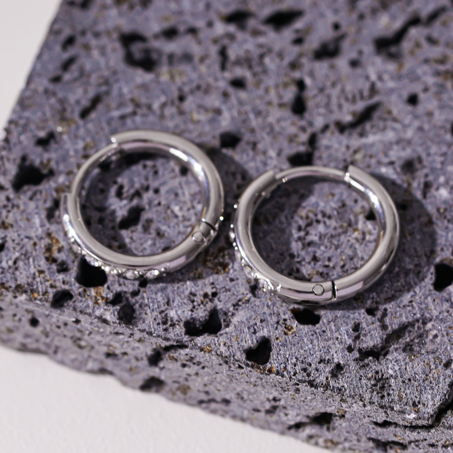 Style DARCI 22117: Pavé Zirconia Gemstones Embedded on a Classic Mini Hoop in Silver.