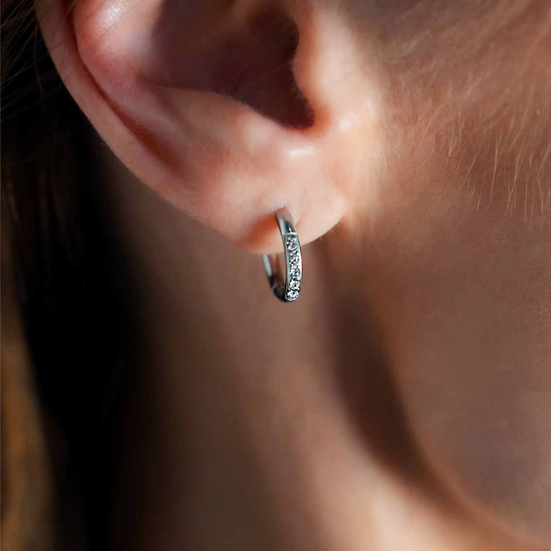 Style DARCI 22117: Pavé Zirconia Gemstones Embedded on a Classic Mini Hoop in Silver.