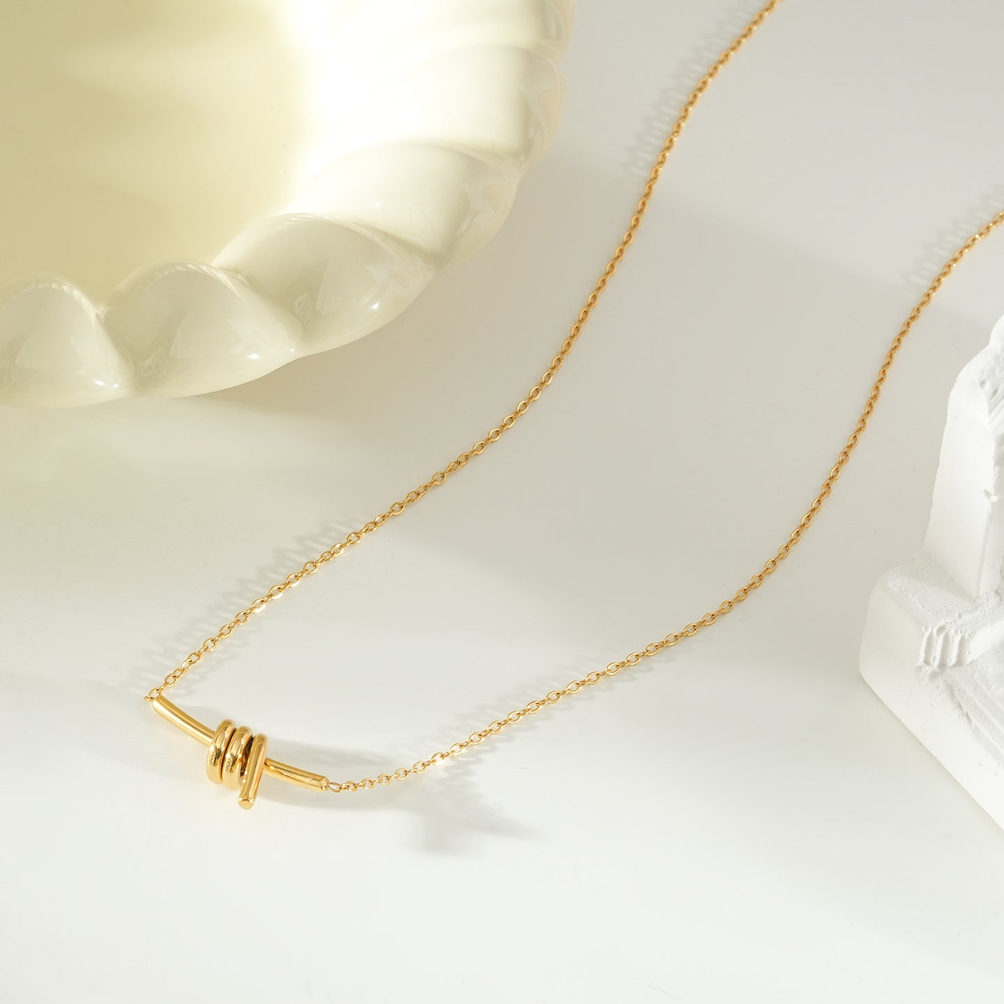 LARISA Gold: Bar Pendant Necklace with Knotted Symbol Detail