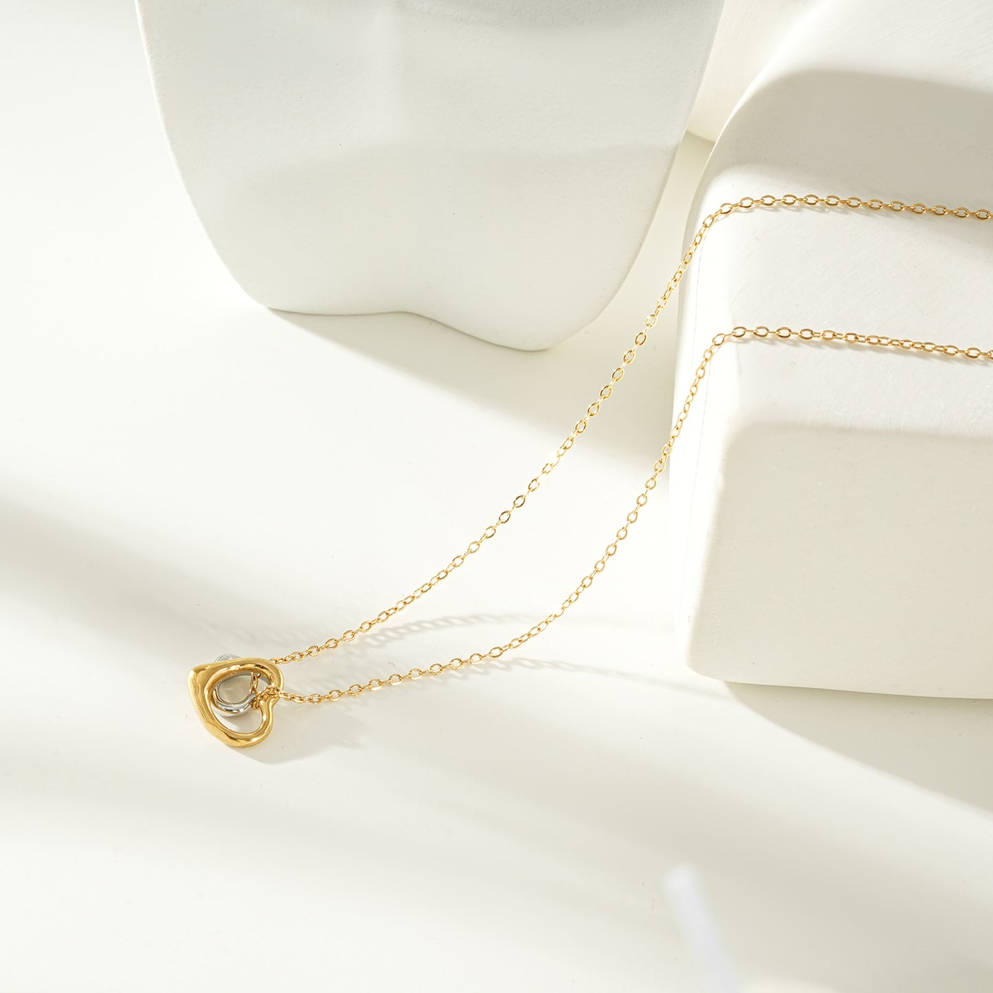 LOLANDA Gold+Silver: Dainty Gold Chain Necklace with Two Abstract Heart Charms in Gold & Silver