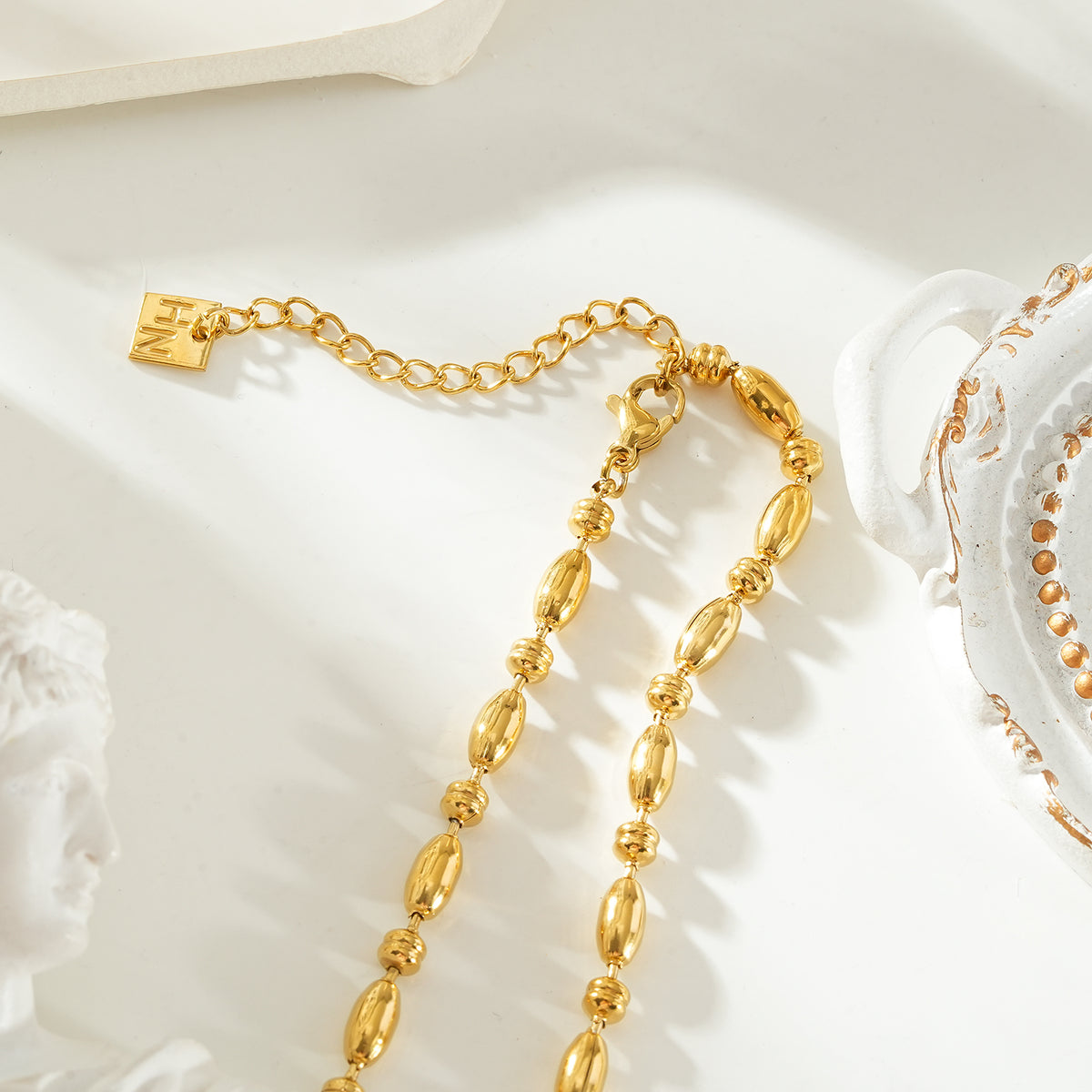 NEEMA Gold: Polished Oval Bead Necklace – Sculpted Statement Jewellery $35