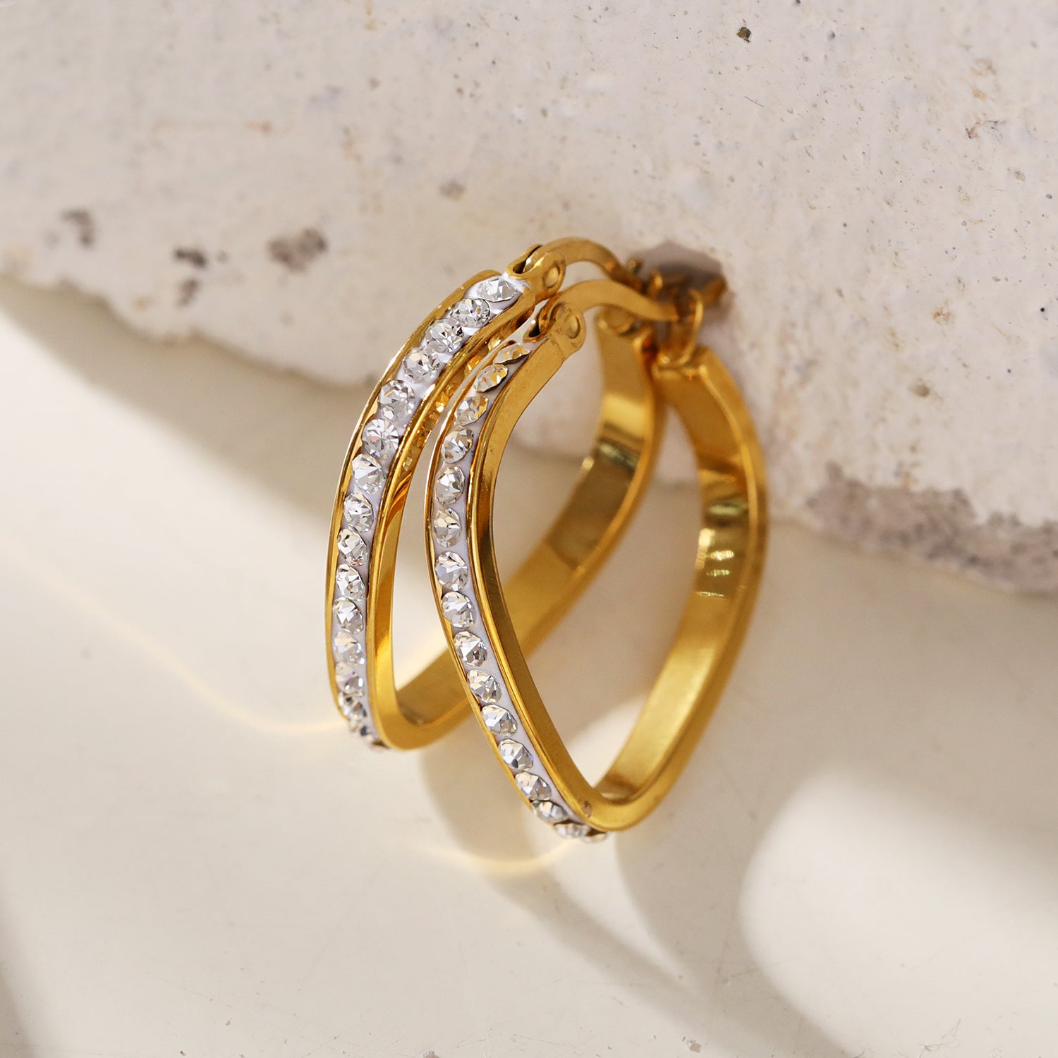 Style MELFI 08565: Rounded Triangle Shaped Hoops embedded with Zirconia Gemstones.